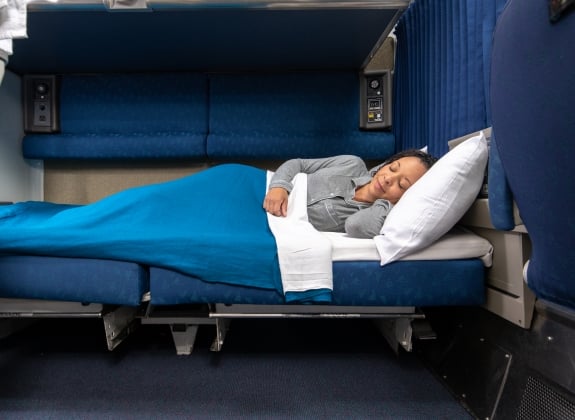 Amtrak Private Sleeping Room woman laying down in amtrak bedroom