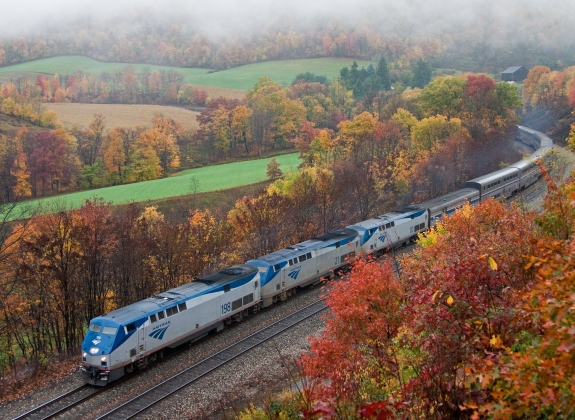 Amtrak's Capital Limited train route through field with autumn foliage