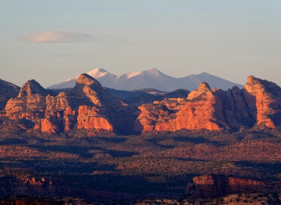 The highest mountains in Arizona, the San Francisco Peaks outside of Flagstaff can be seen through the "canines" of Sycamore Canyon as seen from Perkinsville road, about 10 miles from Jerome.