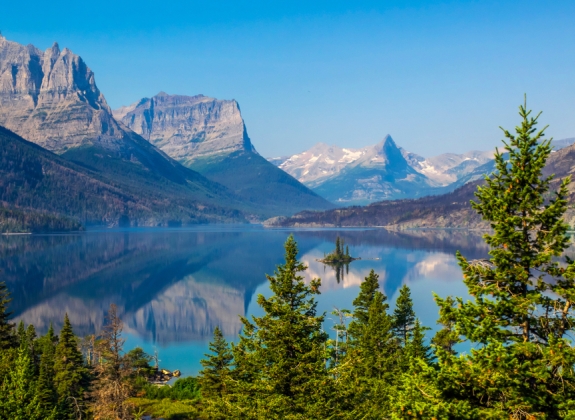 Goose Island in the middle of the St. Mary's lake with mountains peaks and reflection on background in Glacier National Park, Montana.