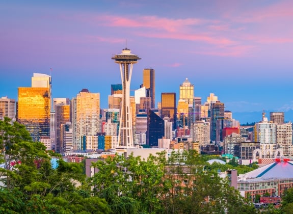 Seattle, Washington, USA downtown skyline at night with Mt. Rainier.