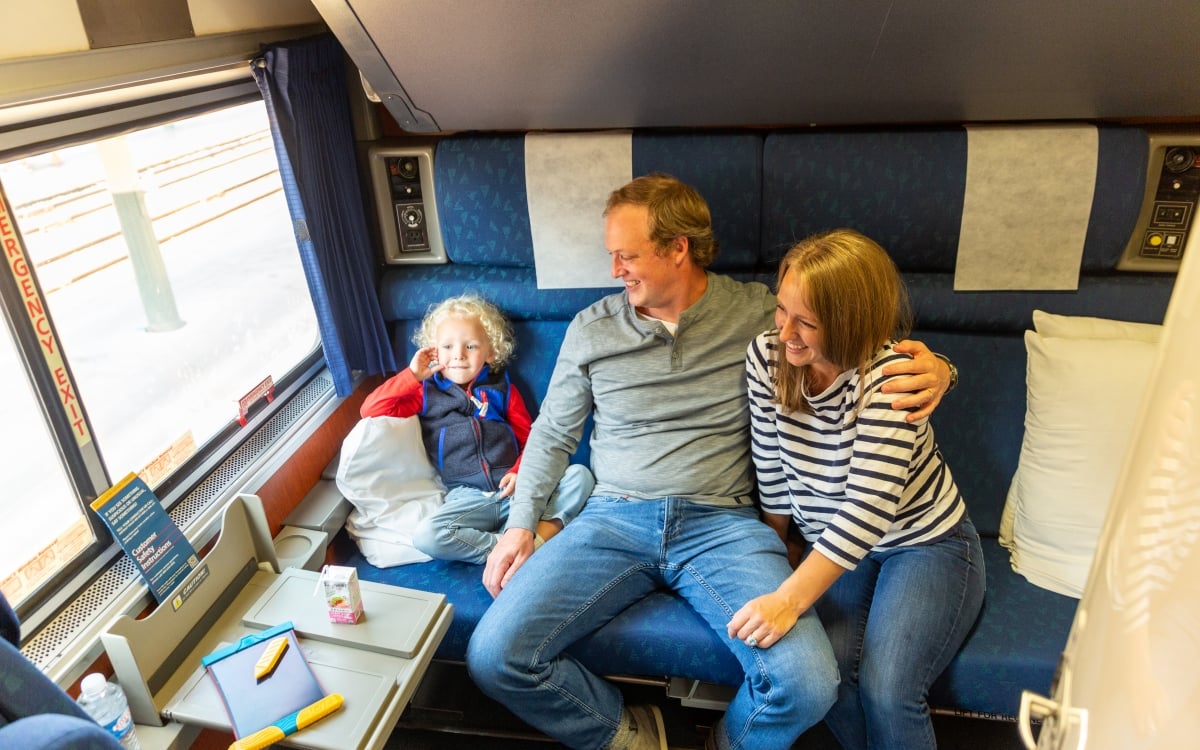 family sitting in private room onboard amtrak