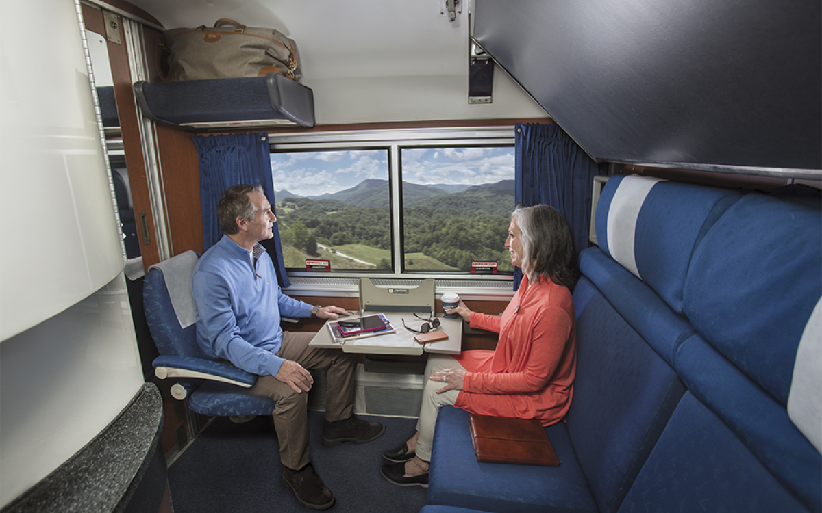 couple sitting in a private amtrak bedroom