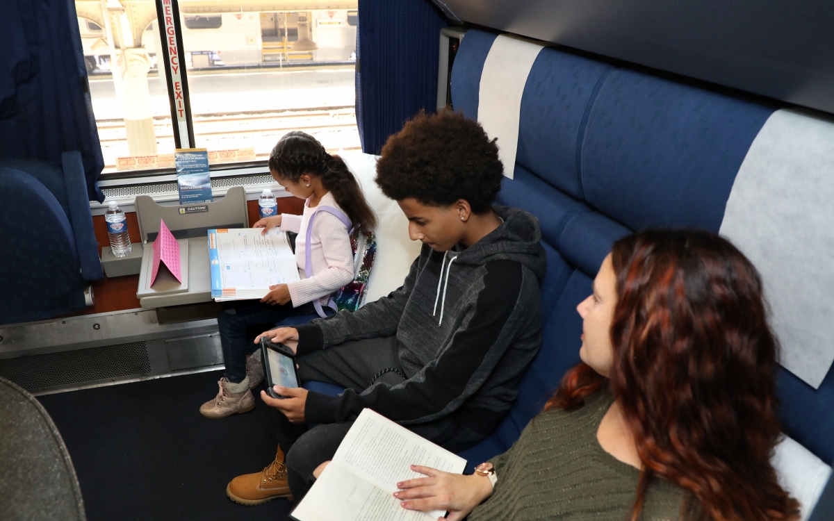 family sitting in private room onboard amtrak