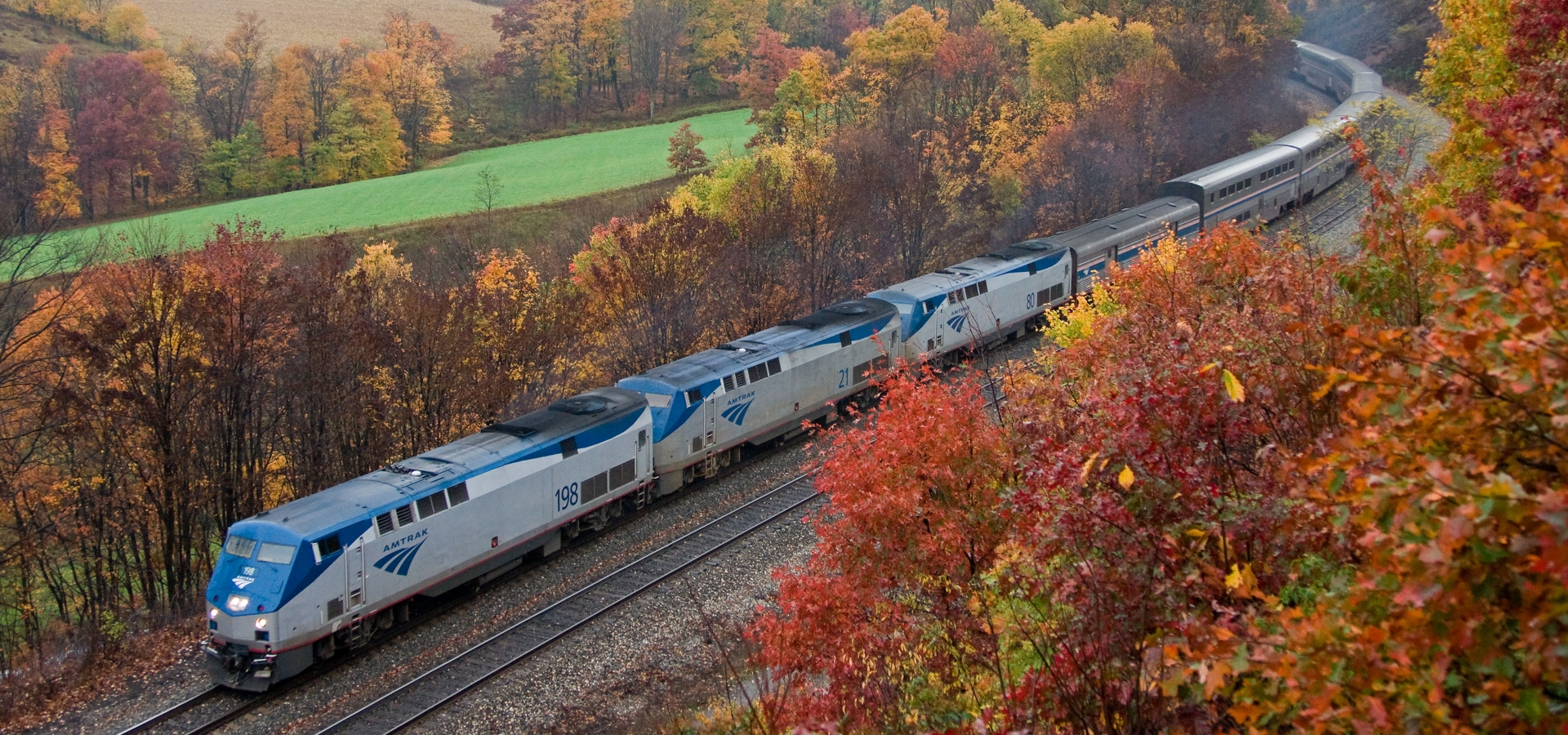 Amtrak's Capital Limited train route through field with autumn foliage