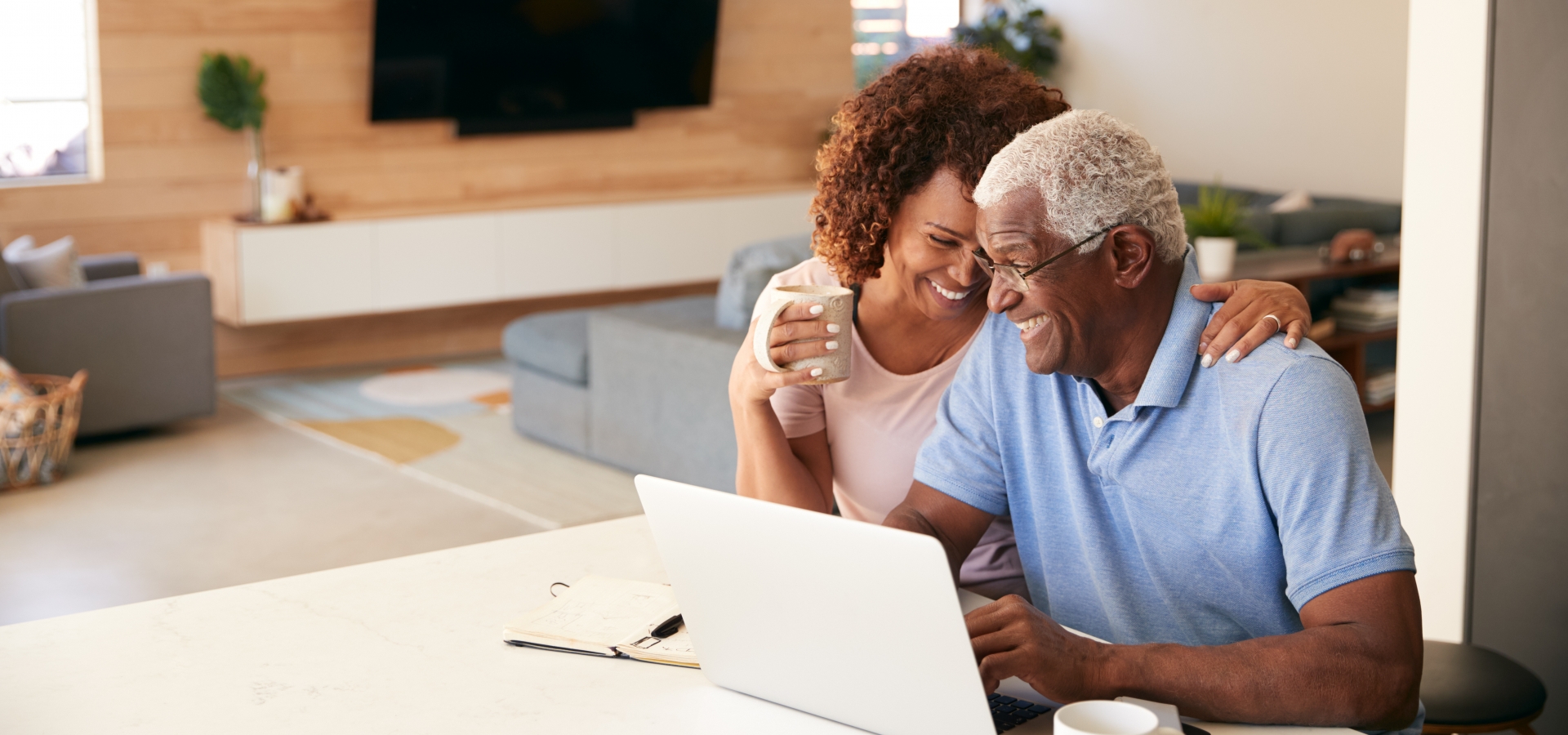 retired couple looking at train vacations on their computer retired couple looking at train vacations on their computer