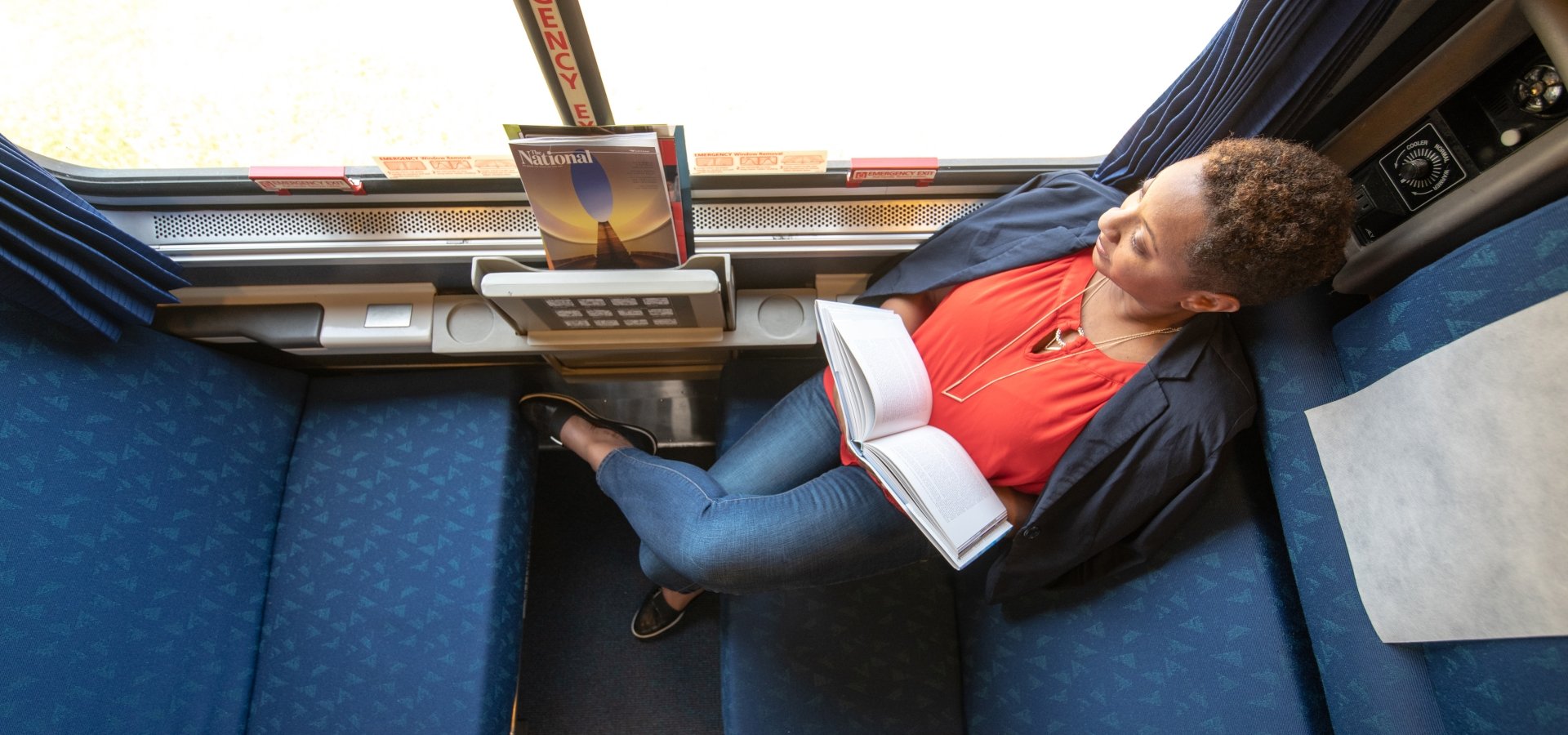 woman sitting in daytime layout of an Amtrak roomette