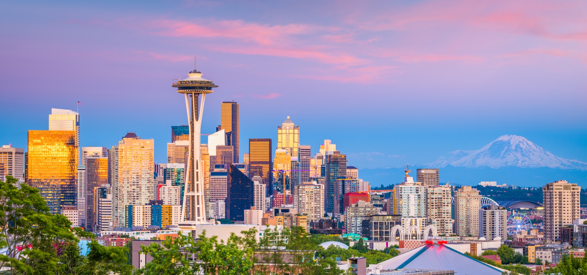 Seattle, Washington, USA downtown skyline at night with Mt. Rainier.