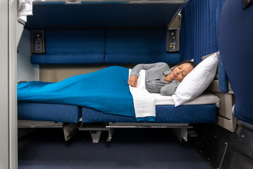 Amtrak Private Sleeping Room woman laying down in amtrak bedroom