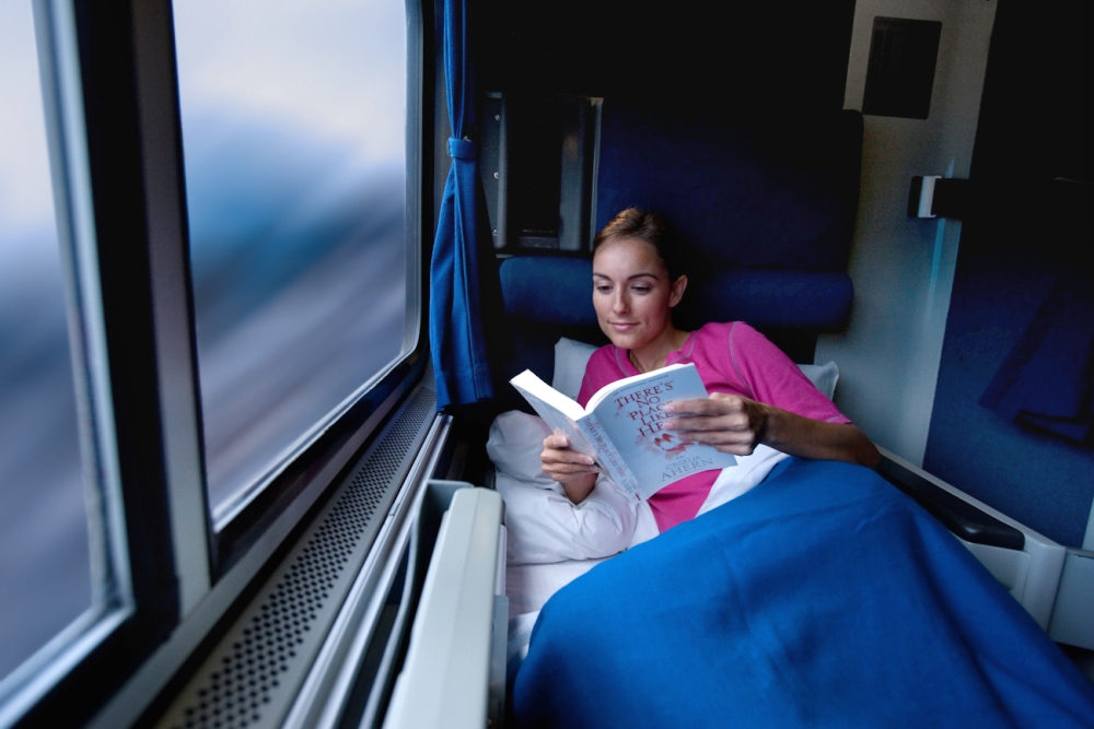 Amtrak Roomette woman reading book in a roomette onboard amtrak