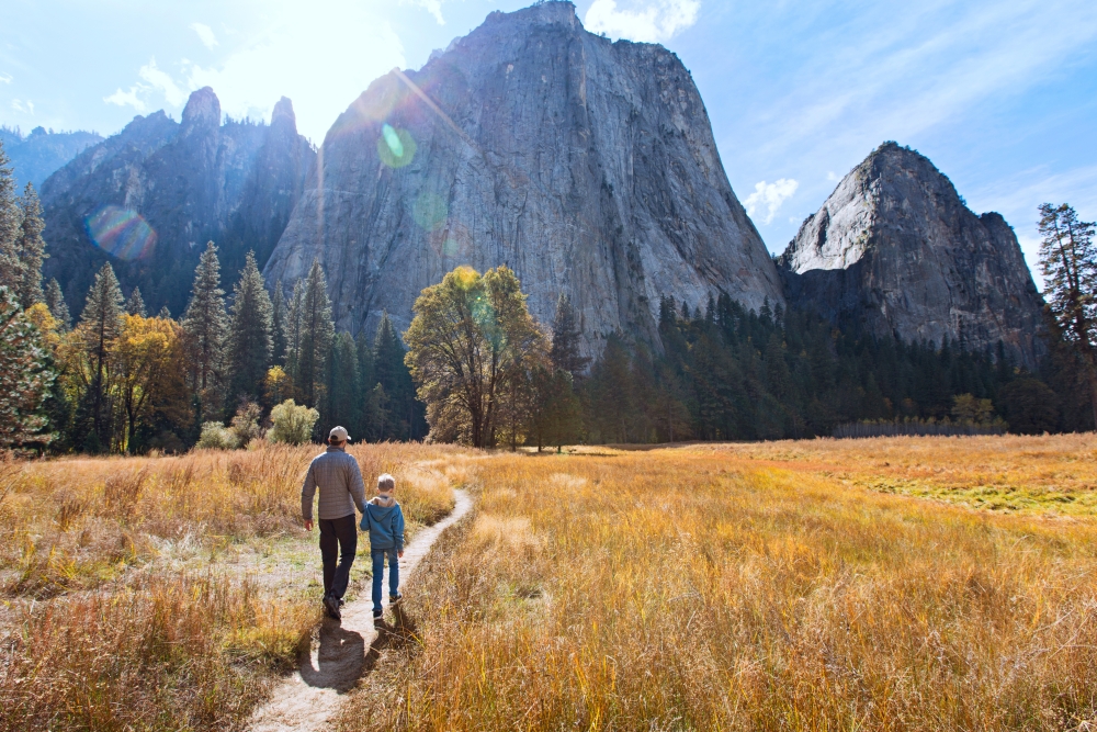 father and son walking el Capitan at Yosemite National Park